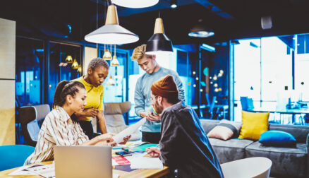 Concentrated young male and female colleagues sitting at meeting