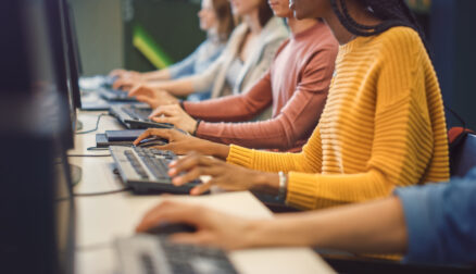 Row of Diverse Group of Multi-Ethnic People Works on PC. Office